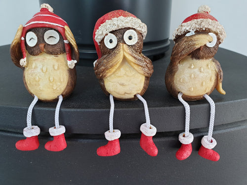 3 shelf sitting owls with red hats , see,hear , speak no evil