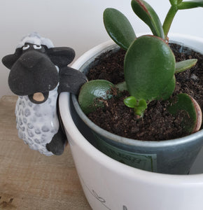 Ceramic sheep or cow pot hugger